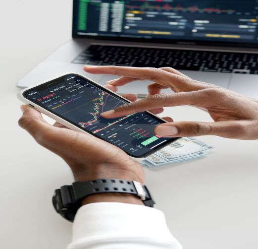 Trader using a trading app to check movements in the FX